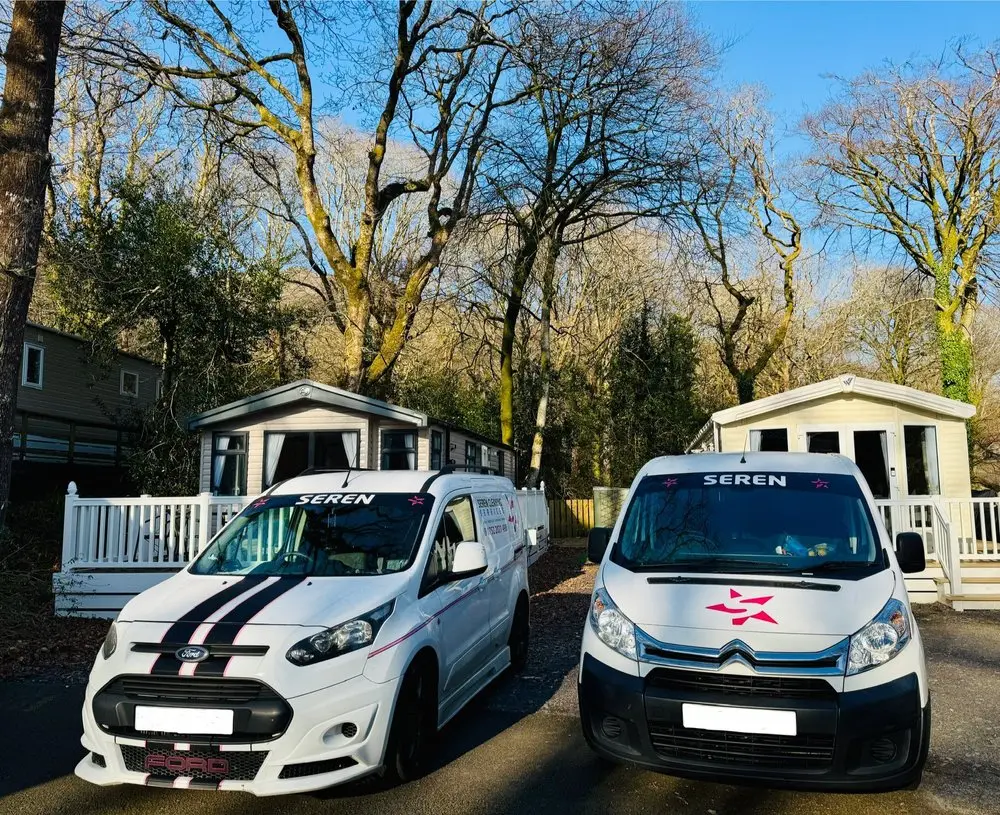 Two Seren Cleaning Services vans at a North Wales holiday park